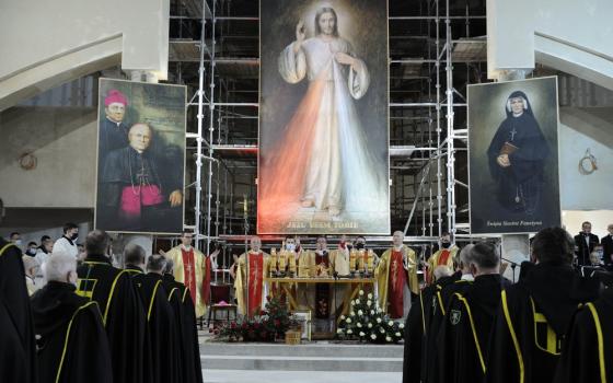Enormous image of divine mercy, flanked by smaller canvases of St. Faustina and clerical sponsor, hang above altar while Mass is celebrated. 