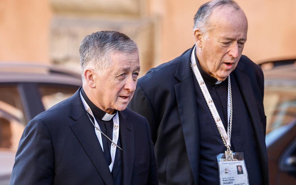 Chicago Cardinal Blase Cupich, left, and San Diego Cardinal Robert W. McElroy arrive for a session of the first assembly of the synod on synodality in the Vatican's Paul VI Audience Hall Oct. 17, 2023. (CNS/Lola Gomez)