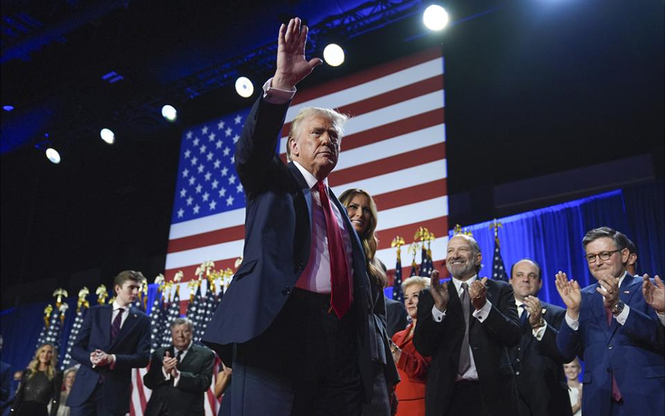 Republican presidential nominee former President Donald Trump waves as he walks with former first lady Melania Trump at an election night watch party at the Palm Beach Convention Center Nov. 6, 2024, in West Palm Beach, Fla. (AP/Evan Vucci)